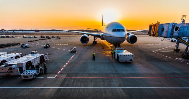 A plane is refueled in the evening sun.