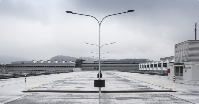 An empty parking lot with double arm floodlights after an NDT test.